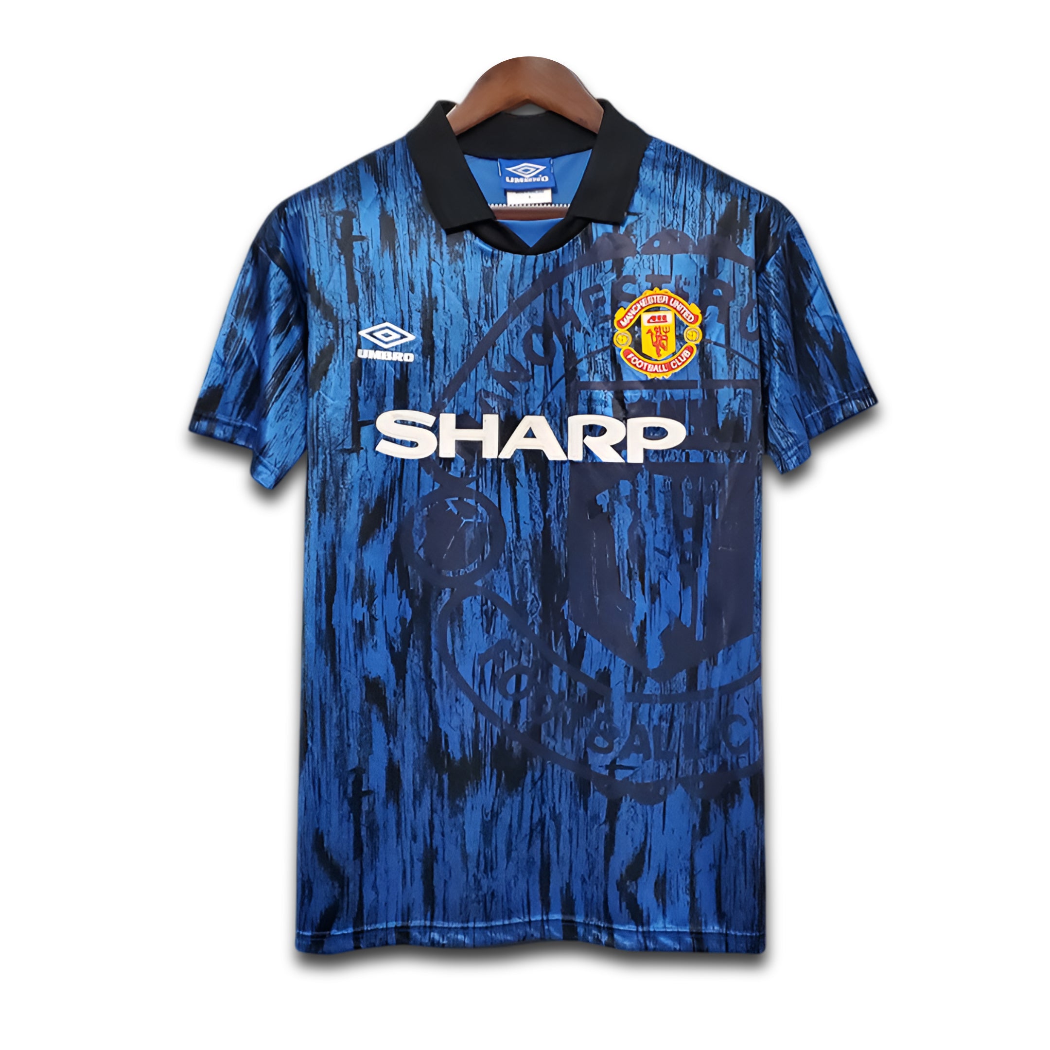Blue Manchester United sports jersey with visible Sharp branding on a white background