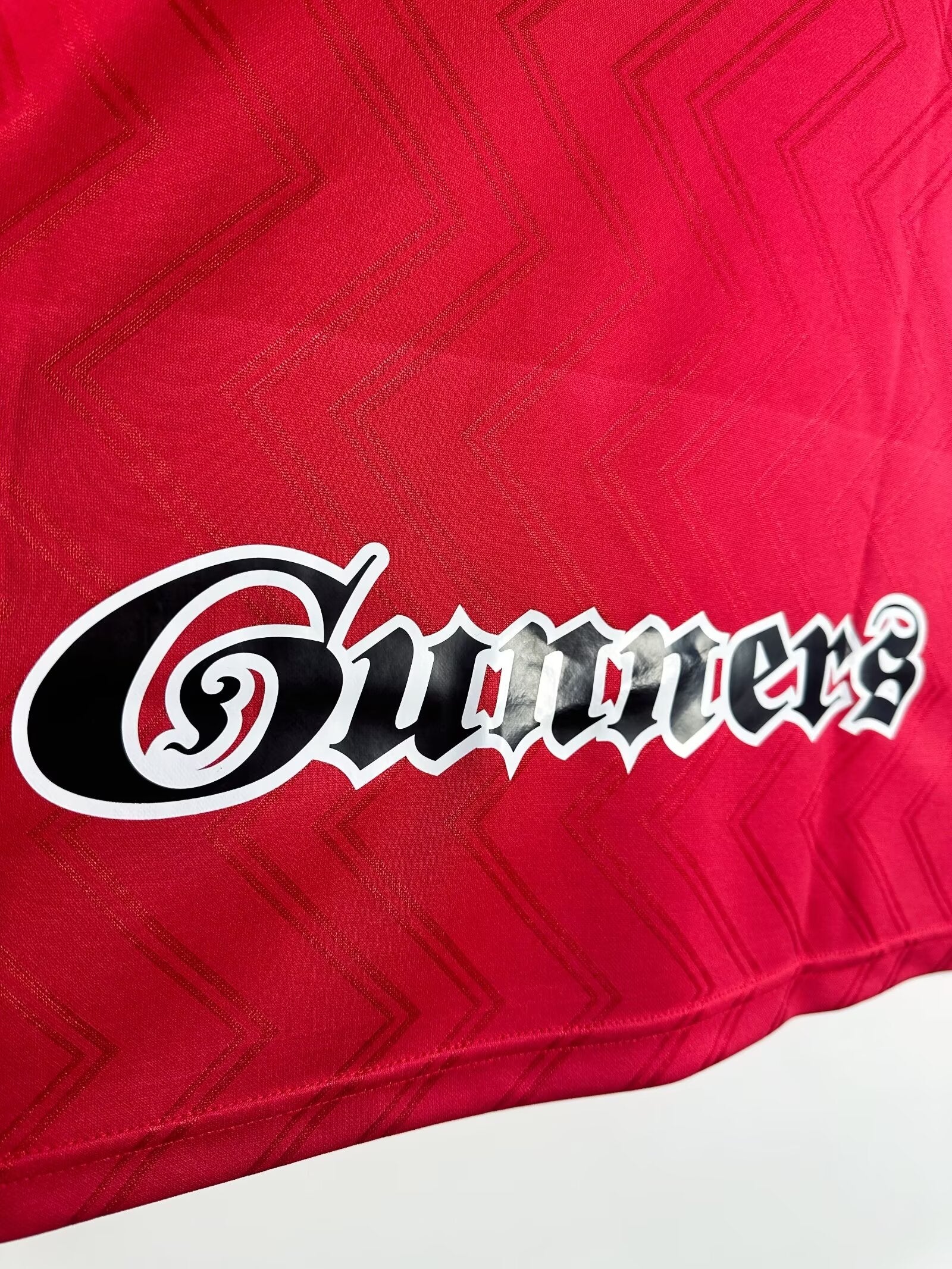 Red fabric with 'Gunners' logo in white and black