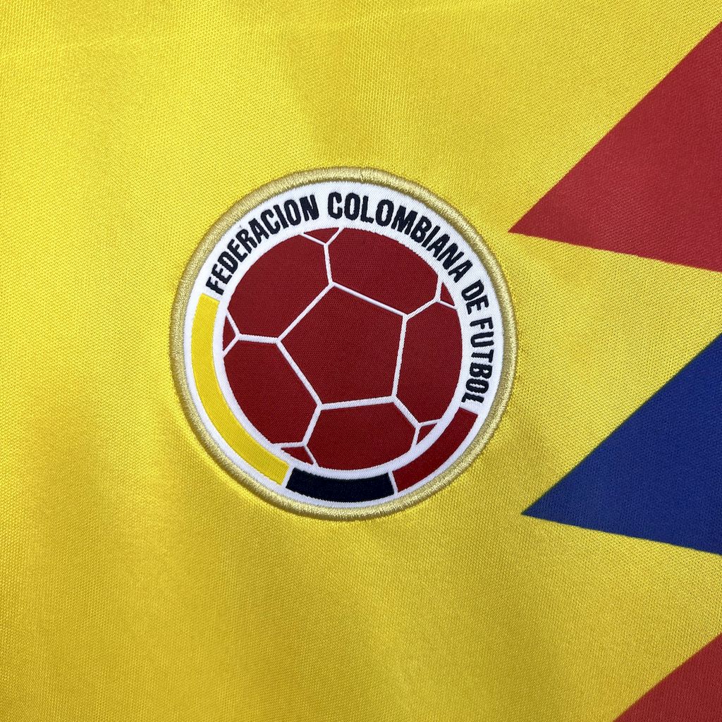 Colombian football federation logo on a yellow background