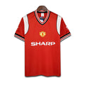 Red Manchester United jersey with 'Sharp' logo on a white background