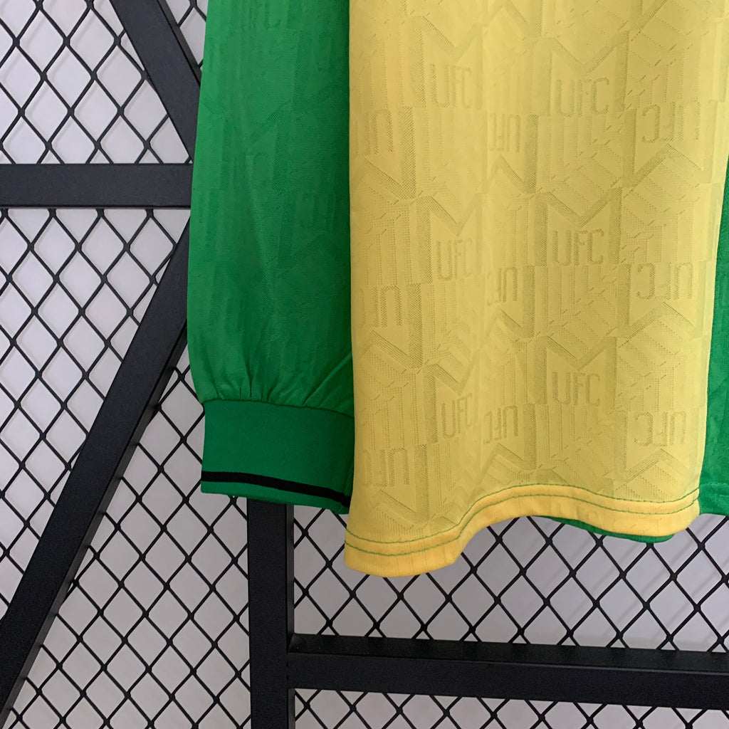Green and yellow textured fabric draped over a black metal frame against a white background