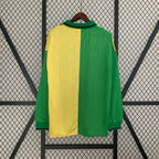 Green and yellow jersey on a hanger against a black and white geometric patterned background