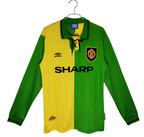 Green and yellow manchester united sports jersey from 1992/1994 with visible branding on a white background