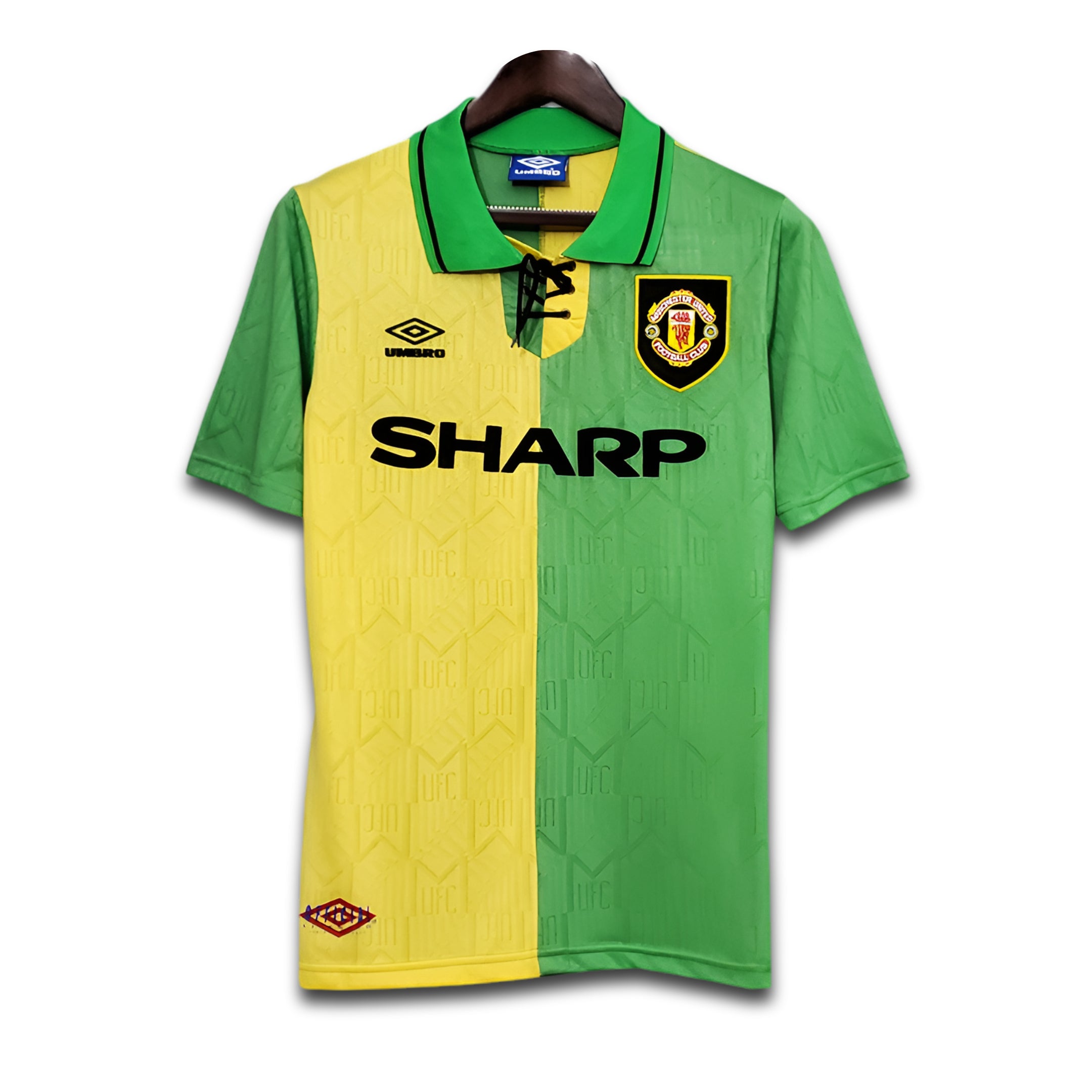 Green and yellow sports jersey with Manchester United logo and 'Sharp' branding on a white background.