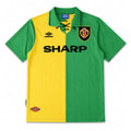 A vintage-style soccer jersey with a vertical split design of green on the right and yellow on the left. The collar is green with lace-up detailing, featuring the black Umbro logo on the right chest, a gold and red club crest on the left chest, and the word 'SHARP' printed across the center in black.
