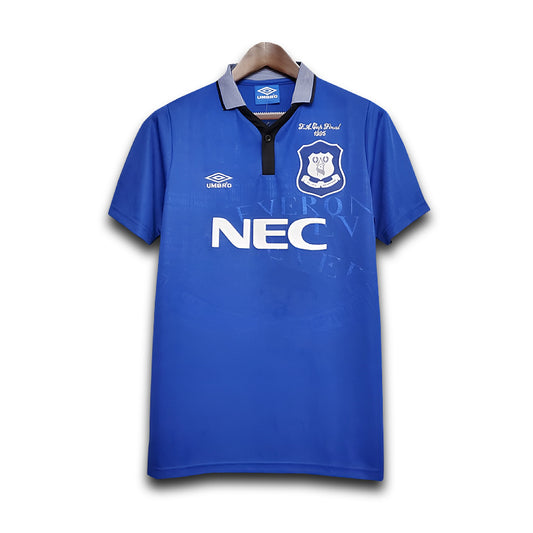 Blue Everton sports jersey with NEC logo on a white background