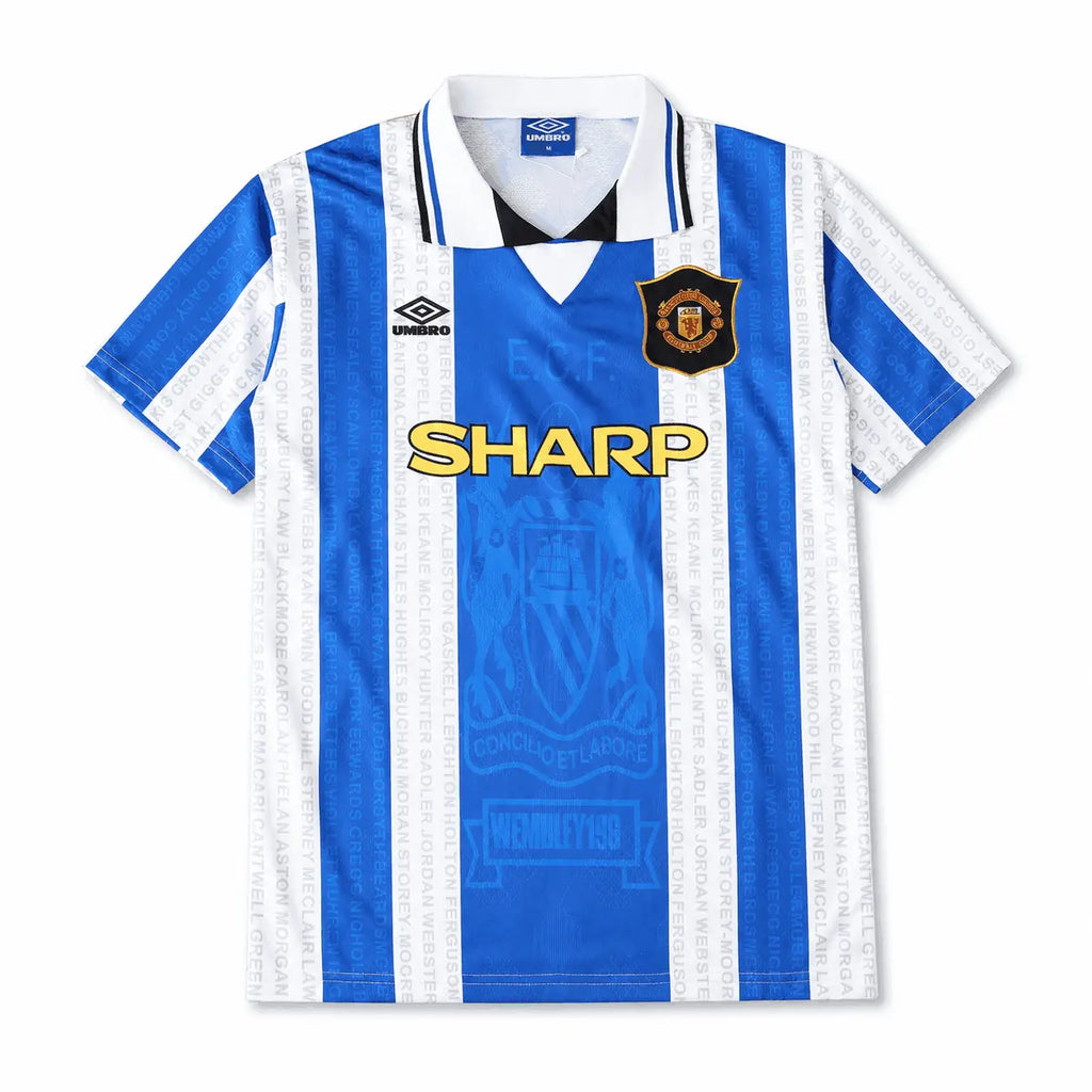 A retro-style football jersey with vertical blue and white stripes, featuring the Umbro logo on the right chest, the Manchester United crest on the left chest, and 'SHARP' in yellow text across the center.