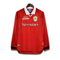 Red Manchester United 1999 UCL jersey with visible SHARP branding on a white background