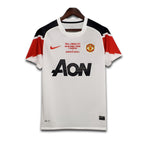 Man United jersey with Nike logo on a hanger against a white background