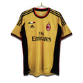 A 2013/14 AC Milan third retro football shirt in gold with black and red detailing, featuring Adidas branding and the Fly Emirates sponsor logo.
