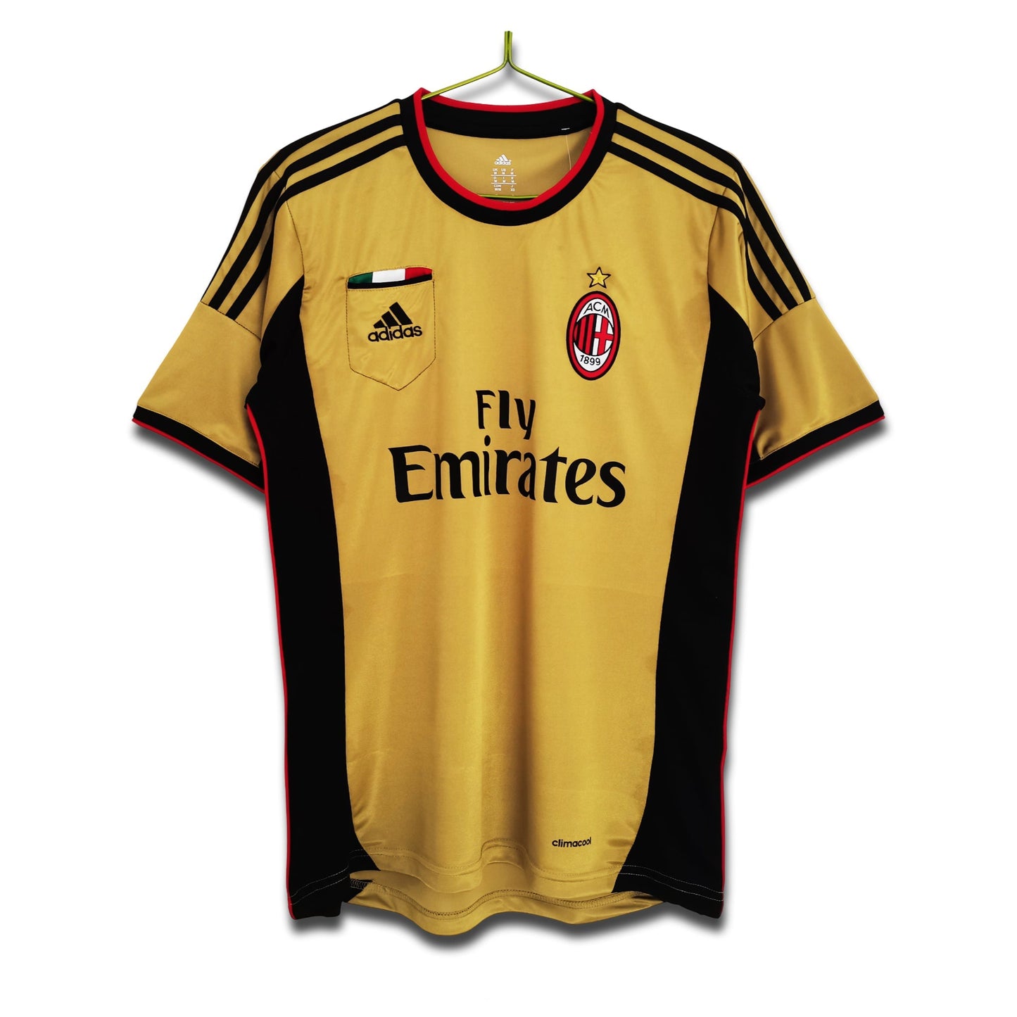 A 2013/14 AC Milan third retro football shirt in gold with black and red detailing, featuring Adidas branding and the Fly Emirates sponsor logo.