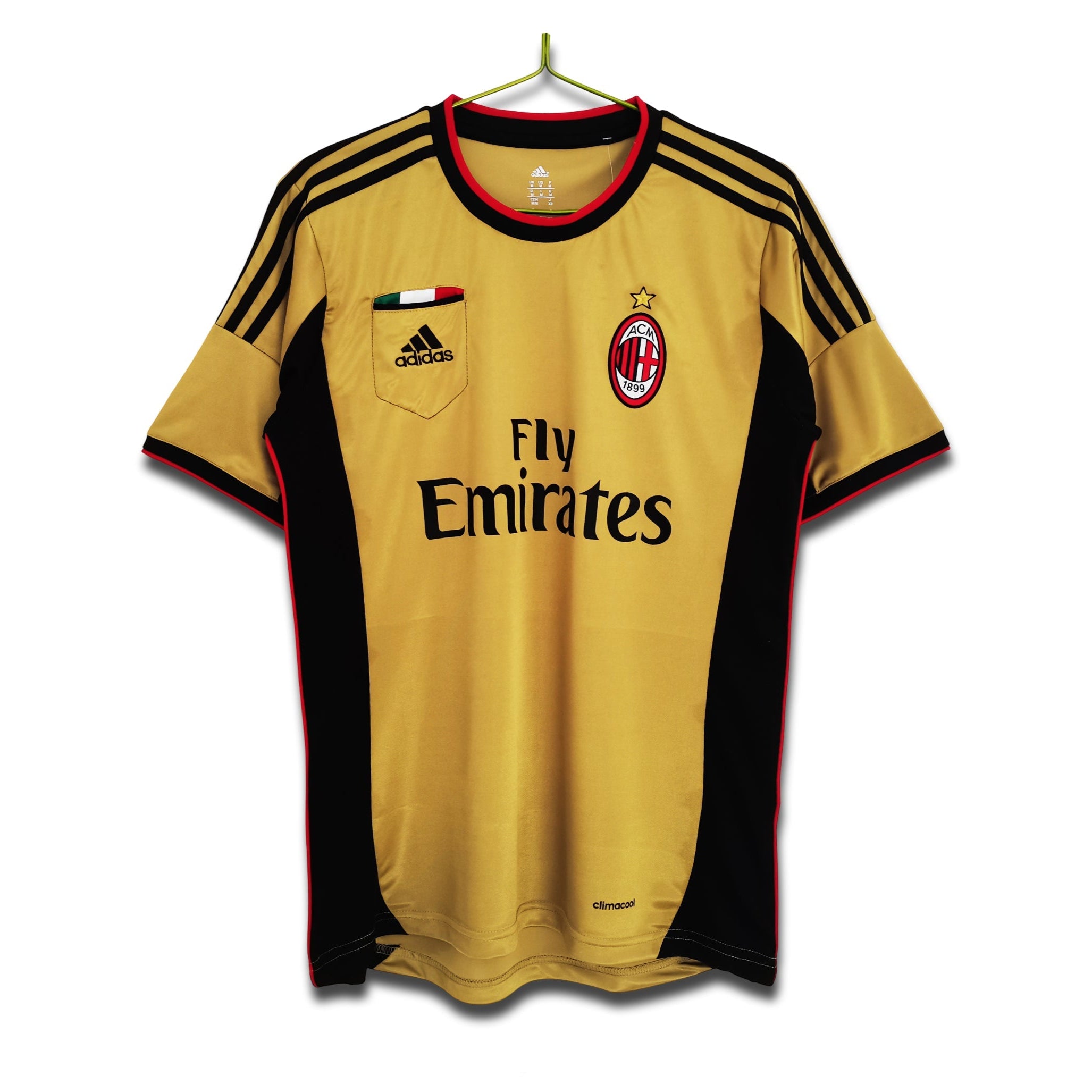 A 2013/14 AC Milan third retro football shirt in gold with black and red detailing, featuring Adidas branding and the Fly Emirates sponsor logo.