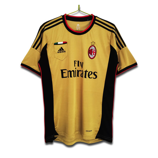 A 2013/14 AC Milan third retro football shirt in gold with black and red detailing, featuring Adidas branding and the Fly Emirates sponsor logo.