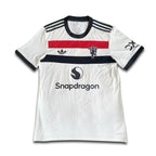 White sports jersey with black, red, and blue accents on a white background