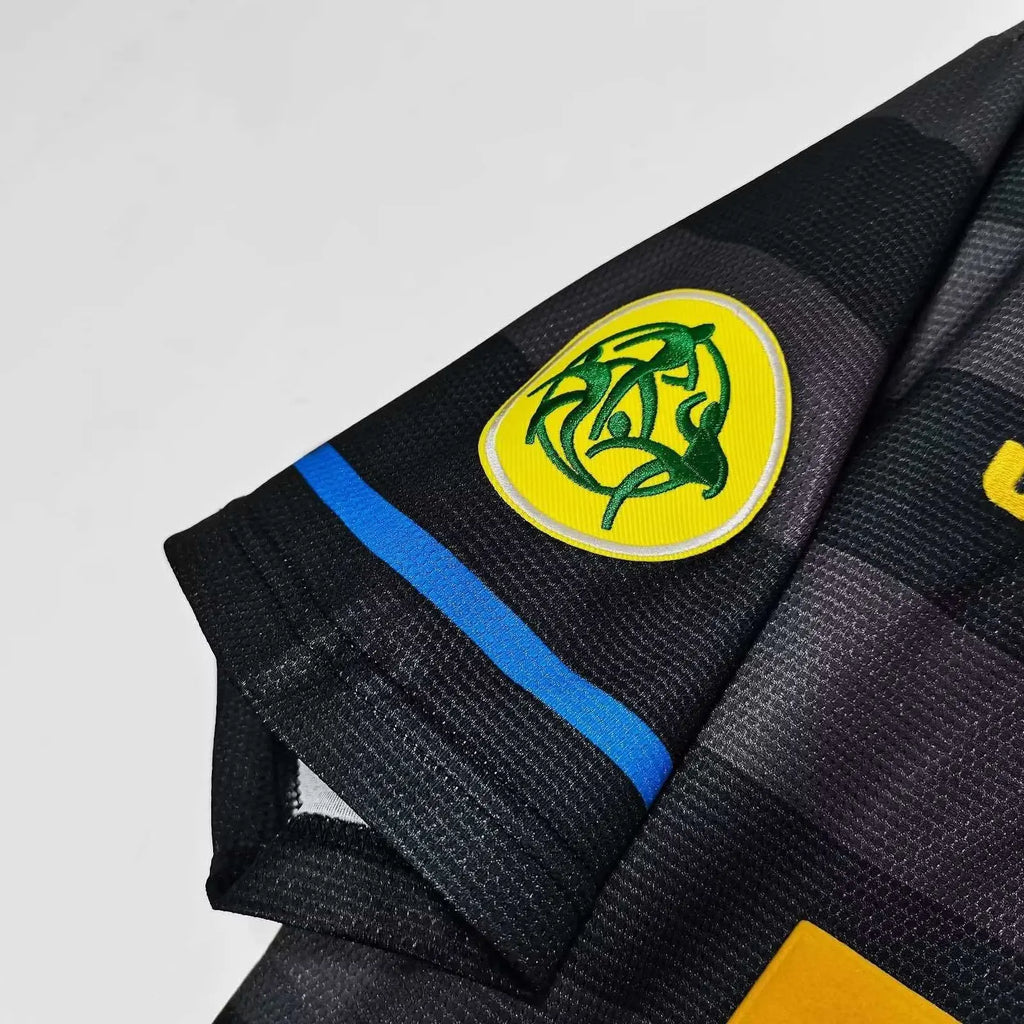 Black martial arts gi with a logo and brand name on a light gray background