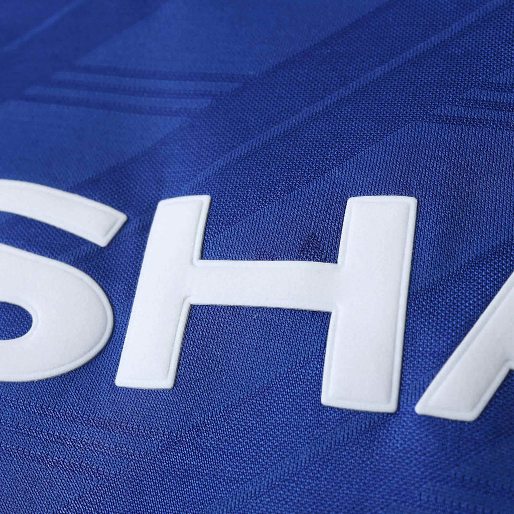 Close-up of a blue sports jersey with white lettering.