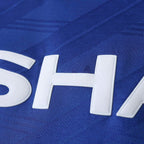 Close-up of a blue sports jersey with white lettering.