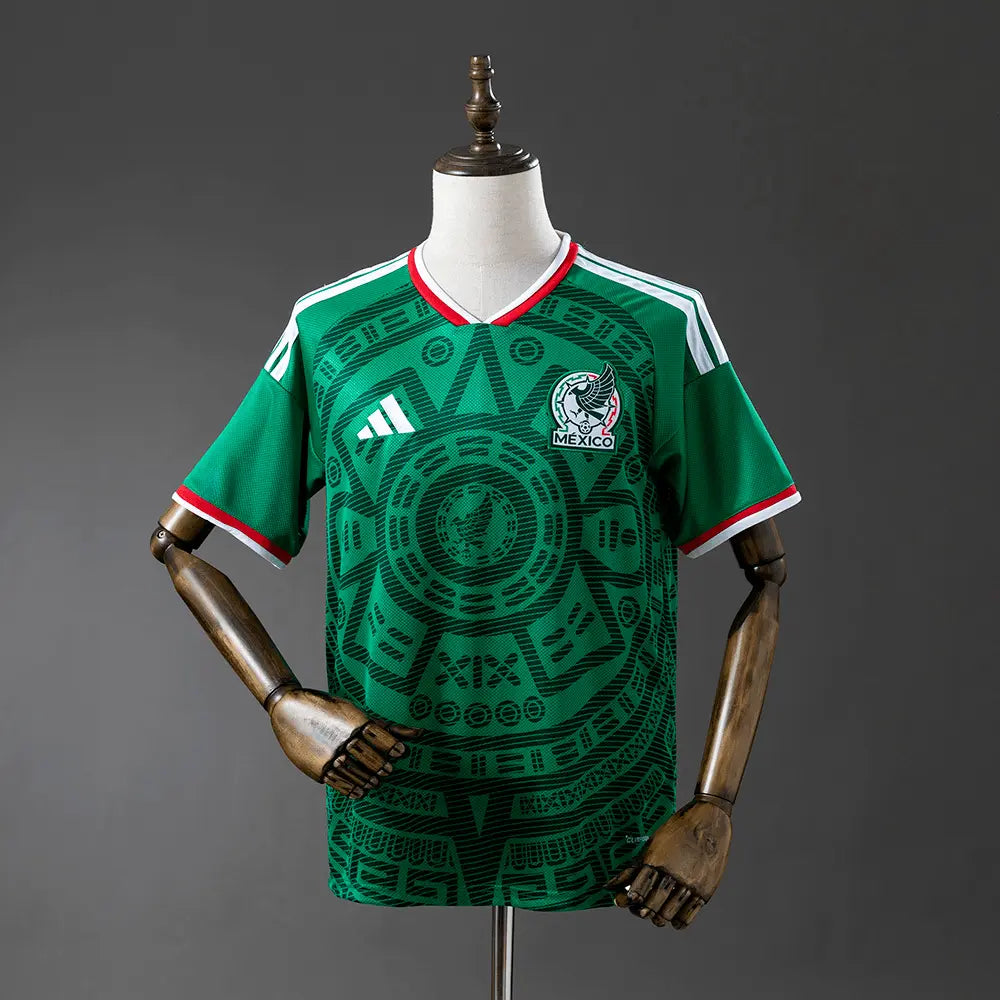 Green sports jersey with a logo on a mannequin against a gray background