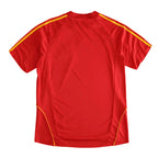 A red short-sleeve athletic jersey shown from the back, featuring yellow piping details along the shoulders and sides, set against a plain white background.