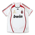 A white AC Milan soccer jersey by Adidas, featuring red and black trim, the 'bwin' sponsor logo, and the Champions League 2004-2005 final patch on the chest.