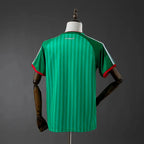 Green striped jersey on a mannequin against a gray background