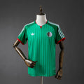 Green Adidas Algeria Home shirt in photoshoot room.