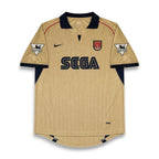 A vintage Arsenal home soccer jersey in beige with navy blue accents, featuring the SEGA sponsor logo on the chest, a Nike swoosh, and the Arsenal club crest.