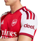 Red and white sports jersey with Arsenal logo and 'deel.' branding.