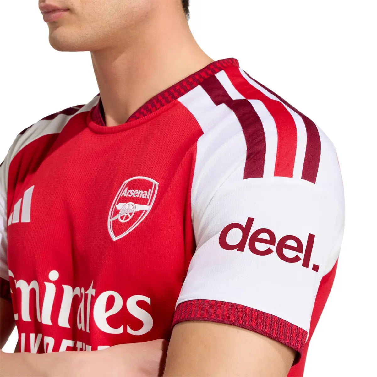 Red and white sports jersey with Arsenal logo and 'deel.' branding.