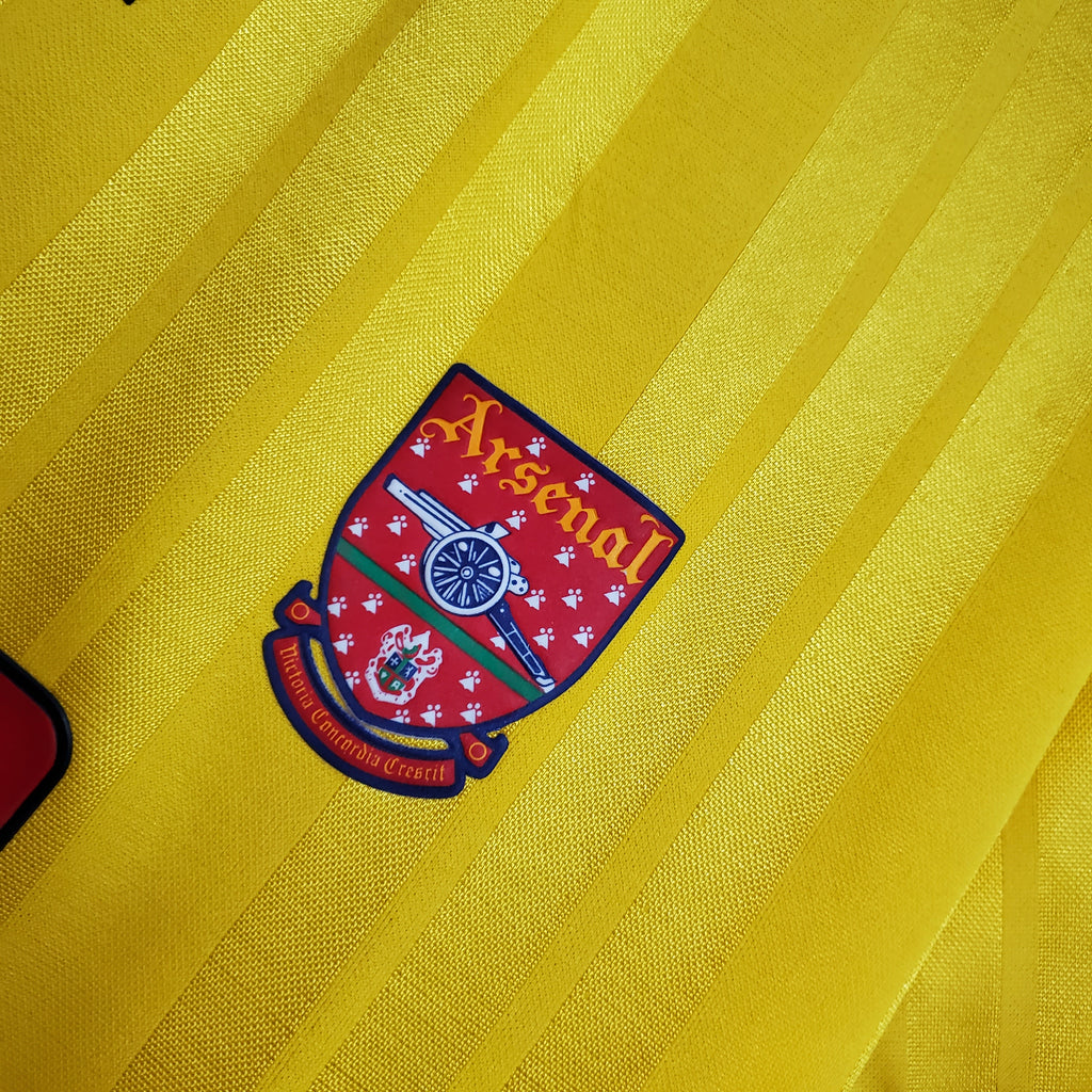 Arsenal logo on a yellow background