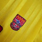 Arsenal logo on a yellow background