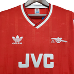 Red Arsenal jersey with Adidas logo and JVC branding on a hanger