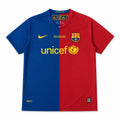 A Nike FC Barcelona home training jersey in a blue and red split design, featuring the yellow Nike swoosh, Unicef sponsor logo, and FC Barcelona crest on the chest.