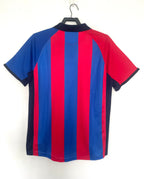 Red and blue striped Barcelona retro shirt on a hanger against a white background