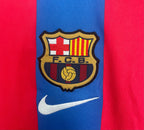 Close-up of a sports jersey with a FC Barcelona logo on a red and blue background