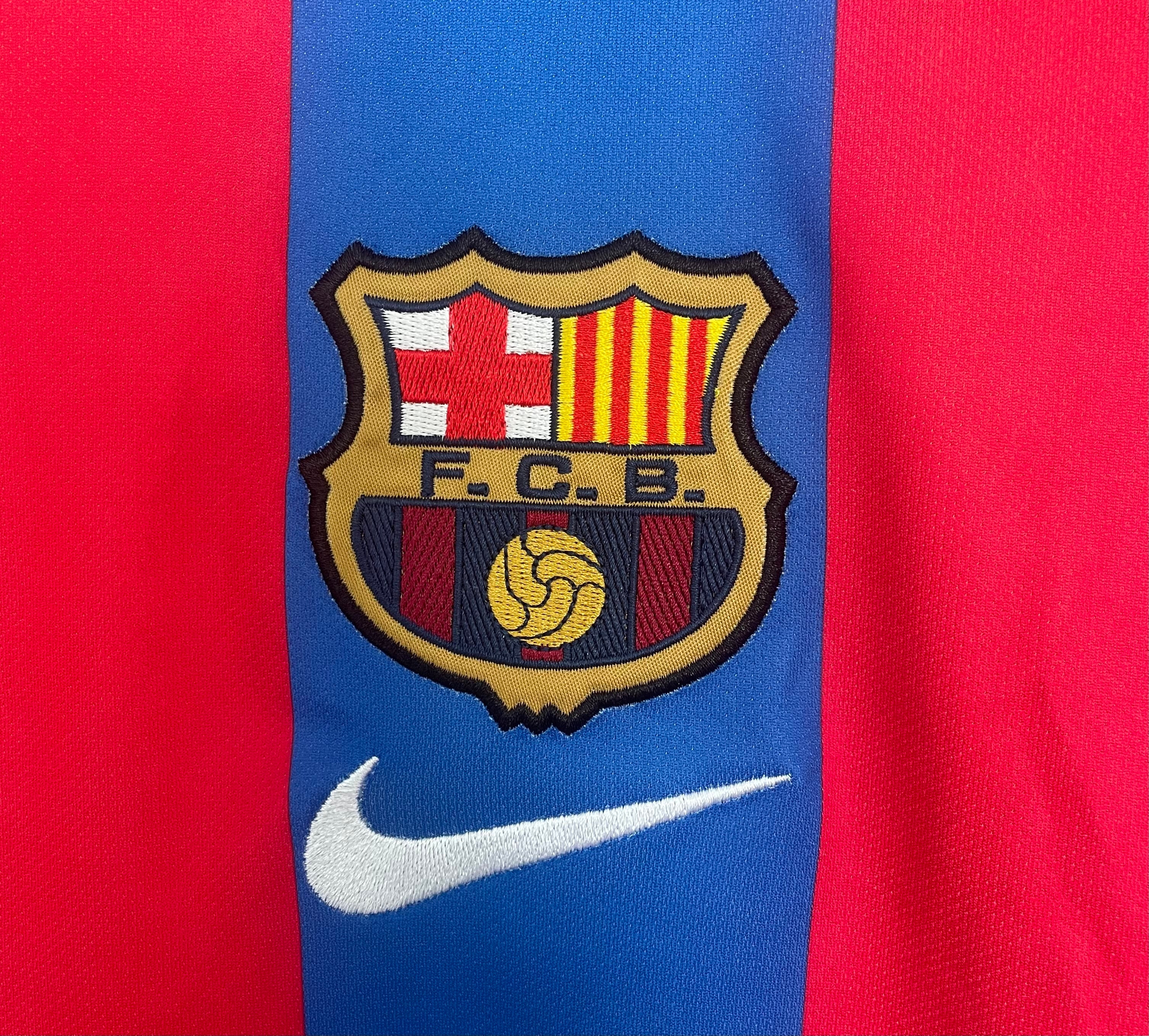 Close-up of a sports jersey with a FC Barcelona logo on a red and blue background