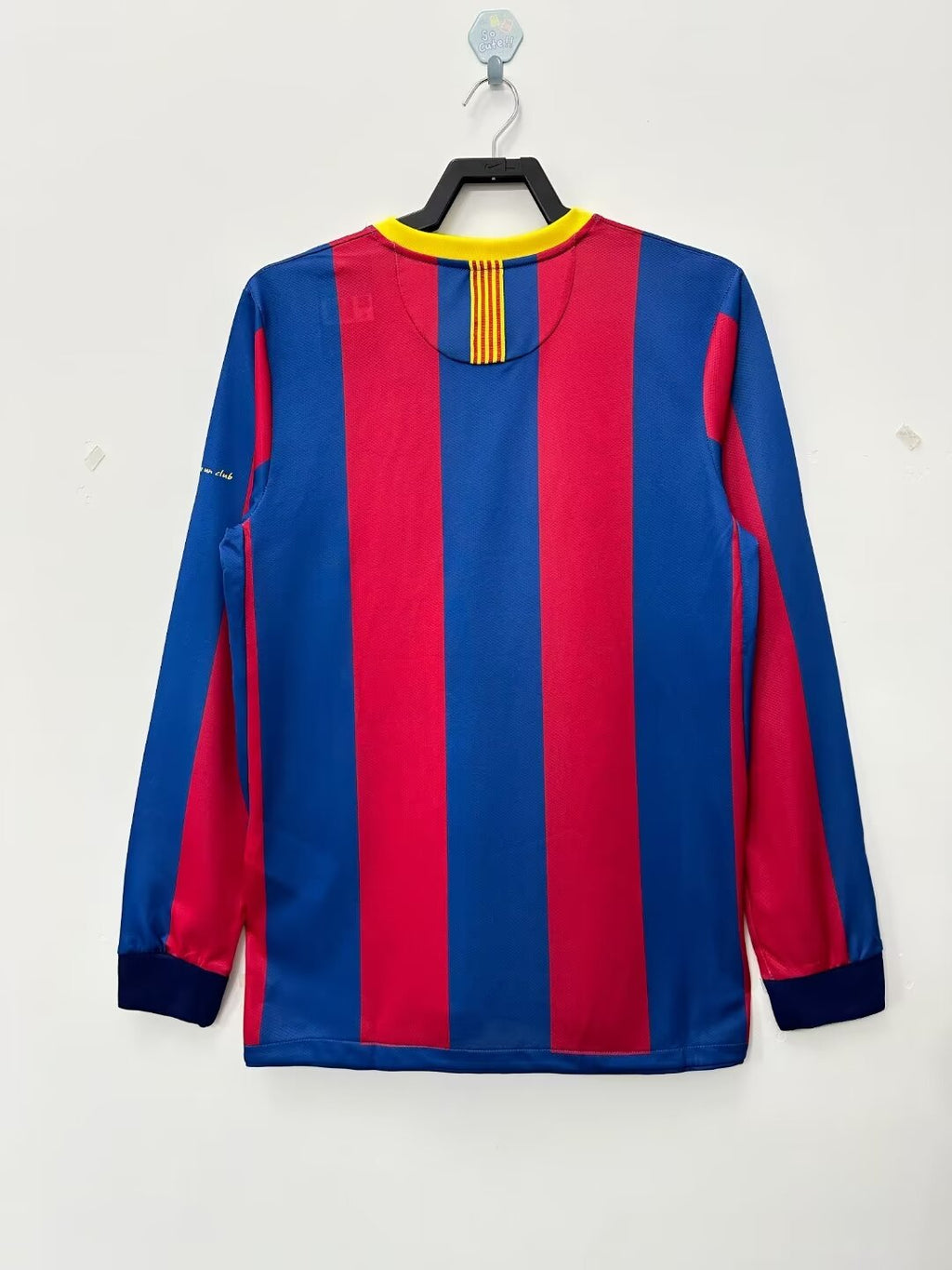 Blue and red striped long-sleeve shirt on a hanger against a white background
