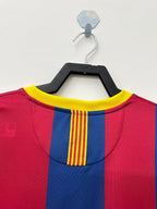 Red and blue sports jersey with yellow accents on a hanger against a white background