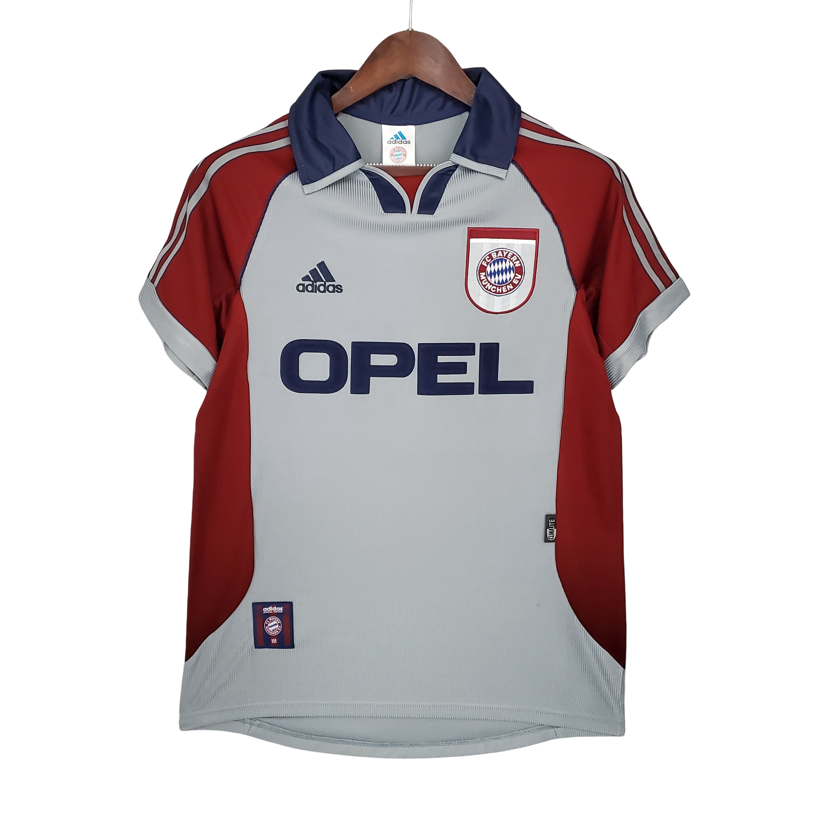 Red and gray sports jersey with Opel and Adidas logos on a hanger