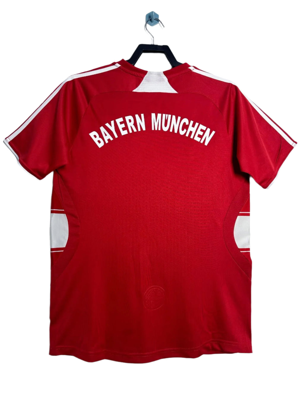 Red Bayern Munich sports jersey on a hanger against a white background