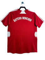Red Bayern Munich sports jersey on a hanger against a white background