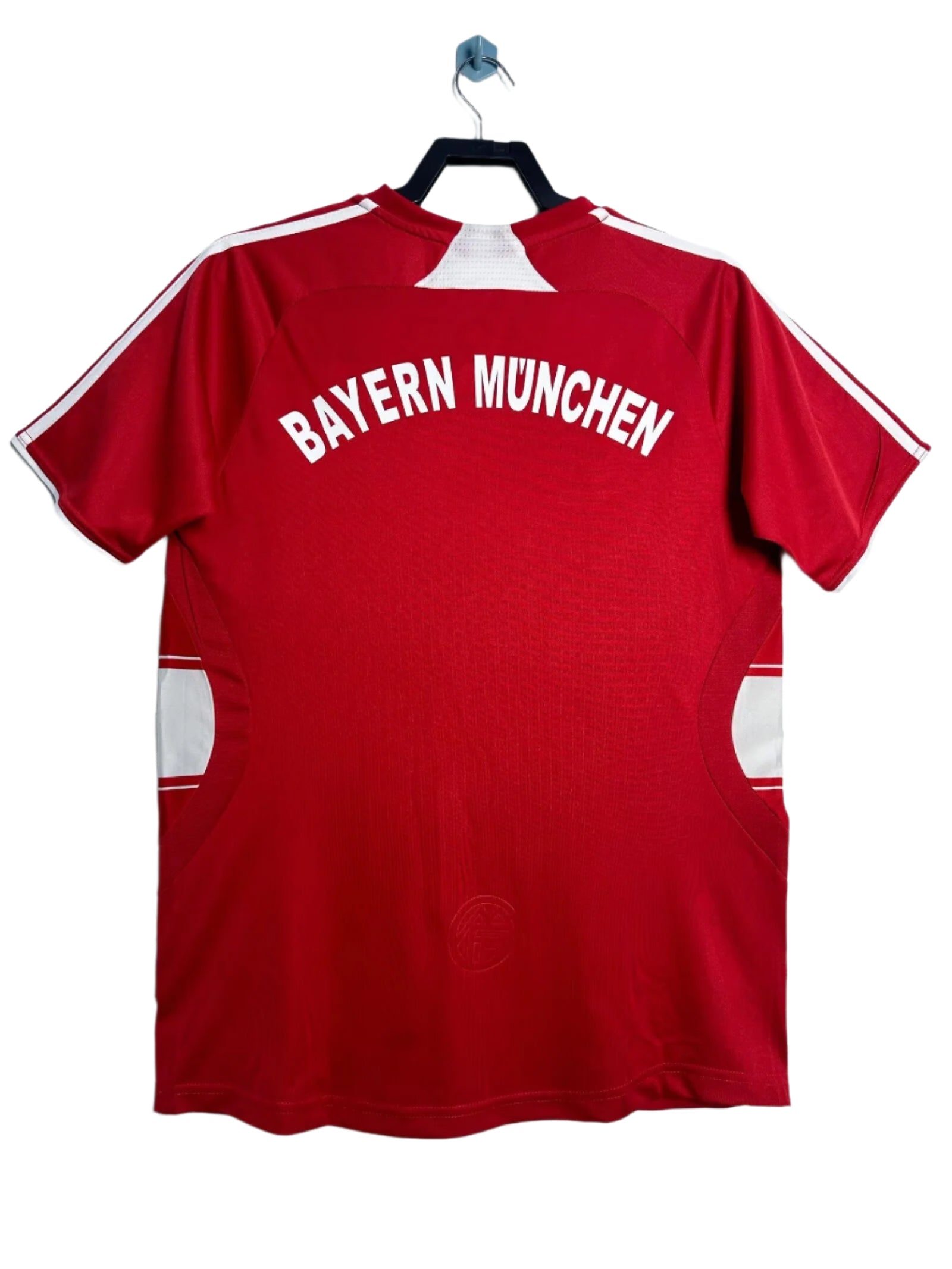 Red Bayern Munich sports jersey on a hanger against a white background
