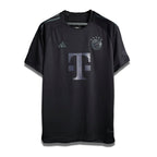 Limited Edition Blackout Home shirt from Bayern Munich's 2023/24 Season, predominantly black with a large 'T' logo on the front.