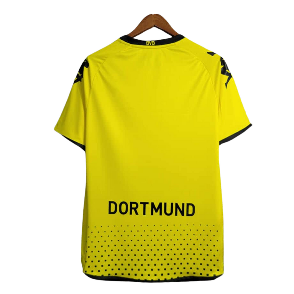 Yellow sports jersey with 'Dortmund' text on a hanger against a white background