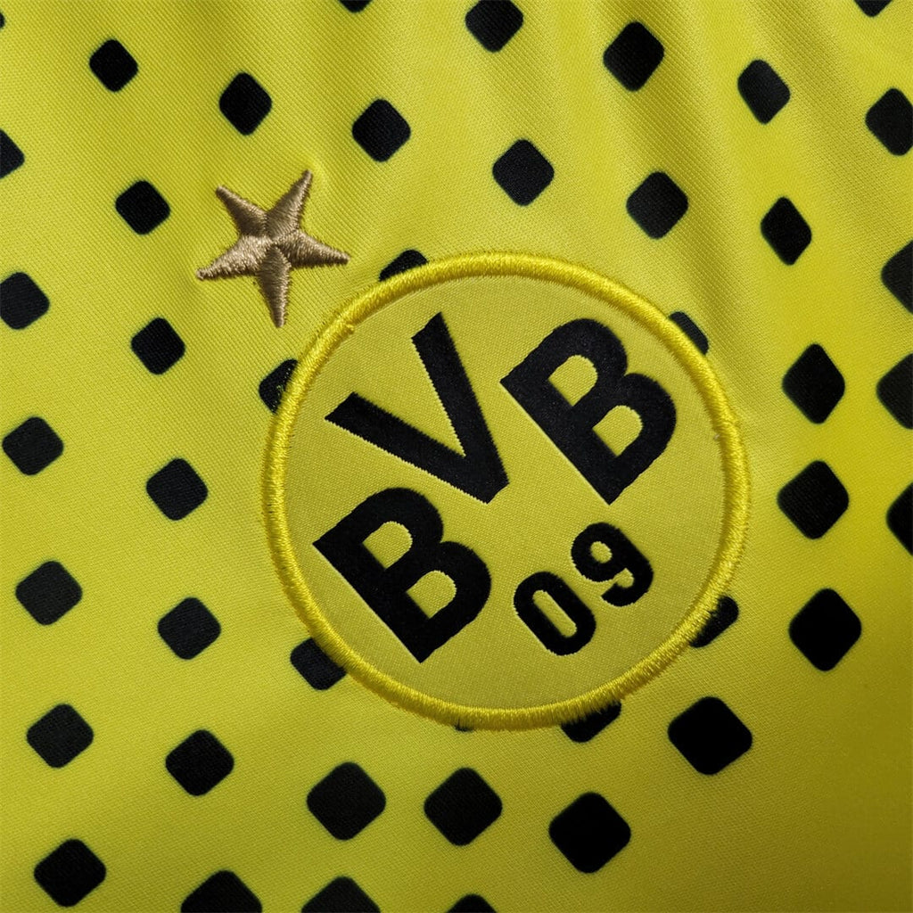 Close-up of a sports kit with BVB logo on a yellow background