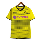 Yellow sports jersey with black patterns and visible branding on a white background