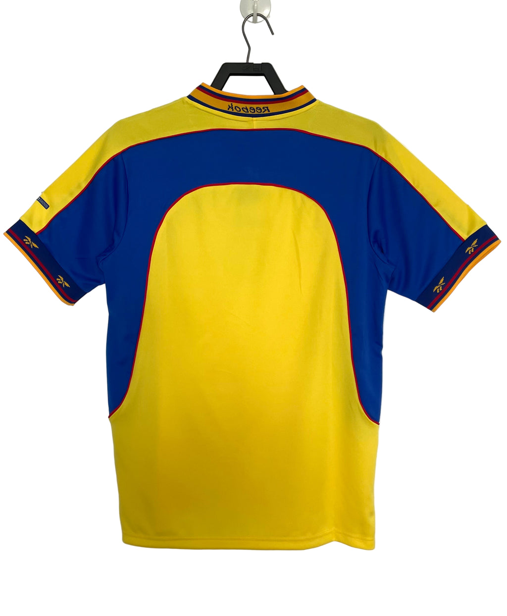 Yellow and blue Colombia soccer jersey on a hanger against a white background