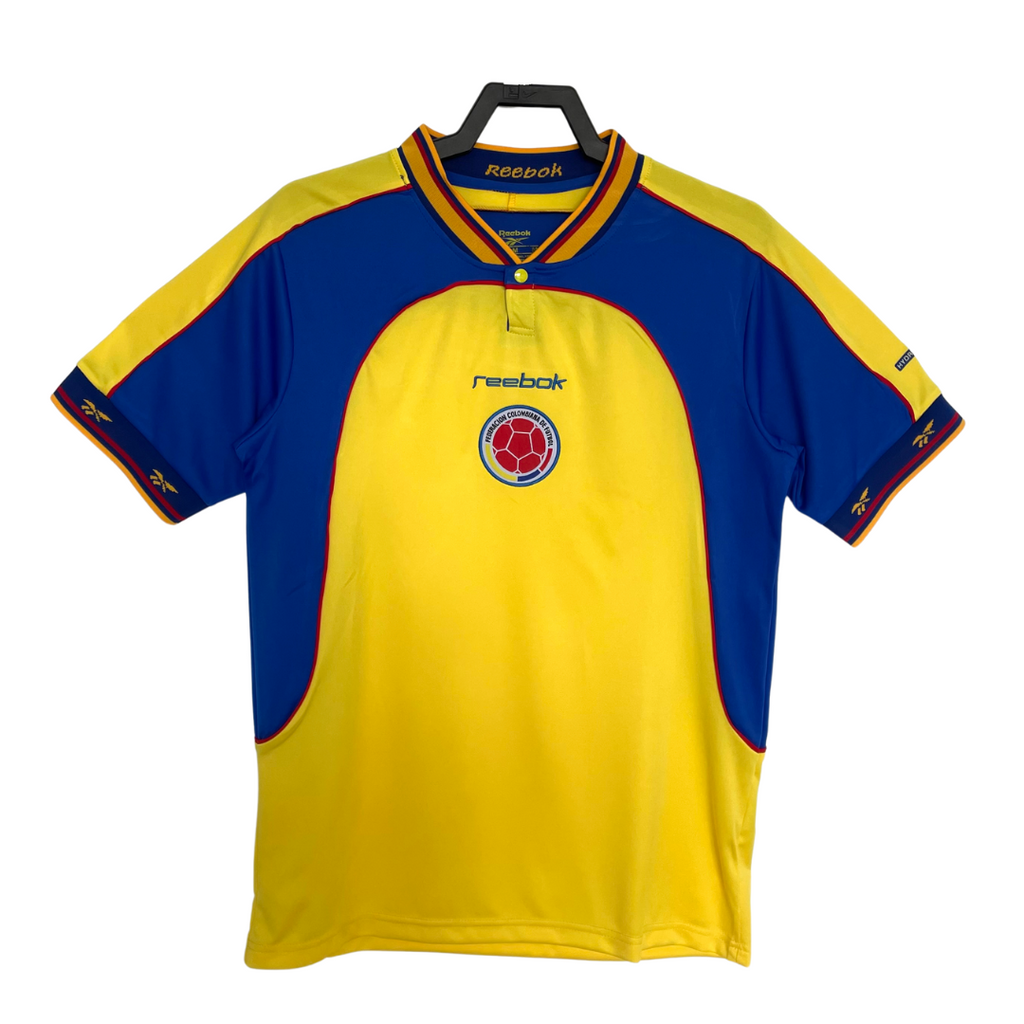 Yellow and blue Reebok Colombia soccer jersey with a logo on a white background