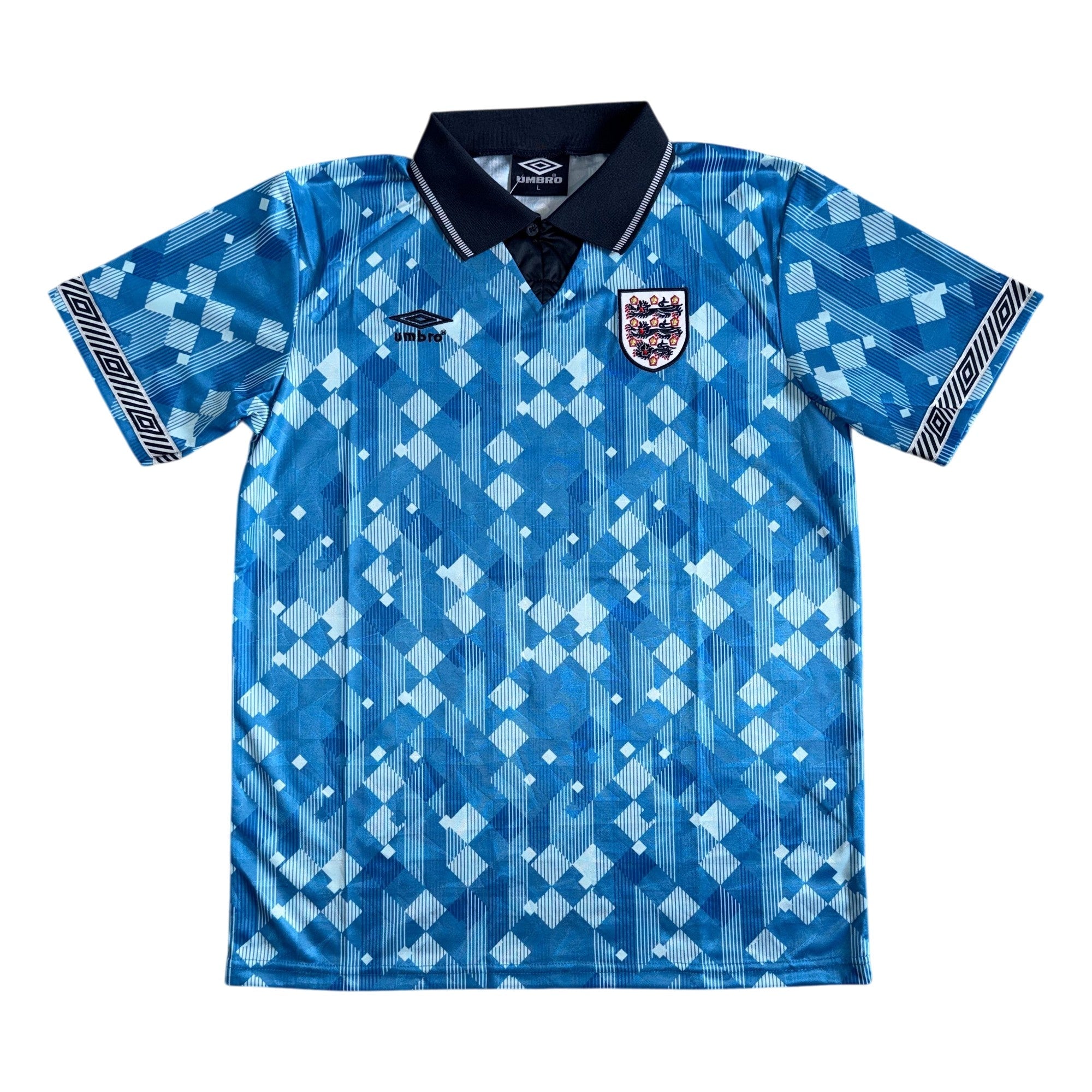 A blue short-sleeve England soccer jersey with a geometric pattern, featuring the Umbro logo on the right chest and the England crest on the left chest, displayed flat against a white background.