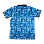 A short-sleeve athletic jersey with a blue and white geometric pattern, featuring a black collar and striped detailing on the sleeve cuffs, shown against a plain white background.